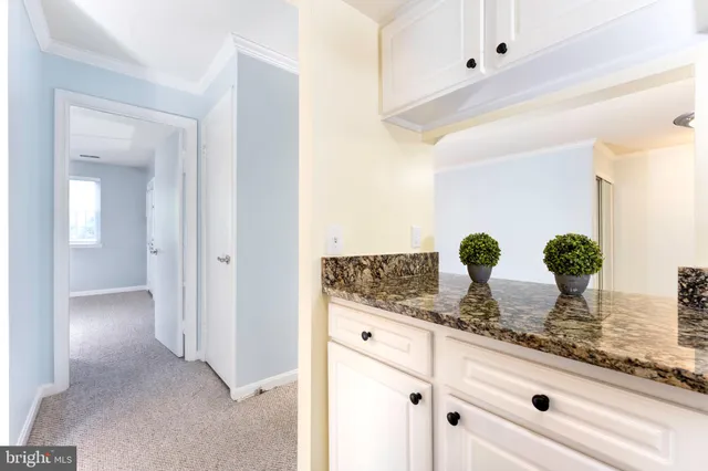 a bathroom with mirror and vanity