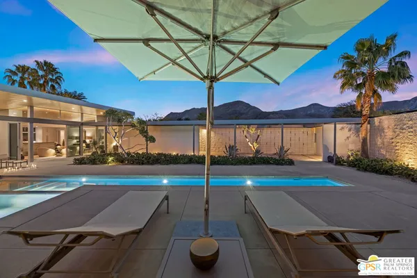 a view of a swimming pool with an outdoor seating