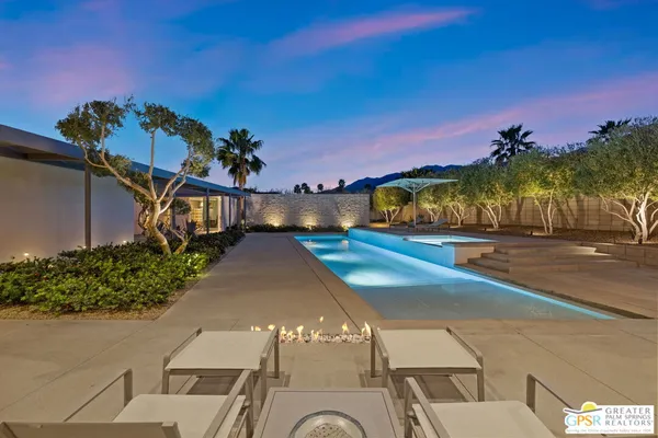 a view of a house with pool and a yard