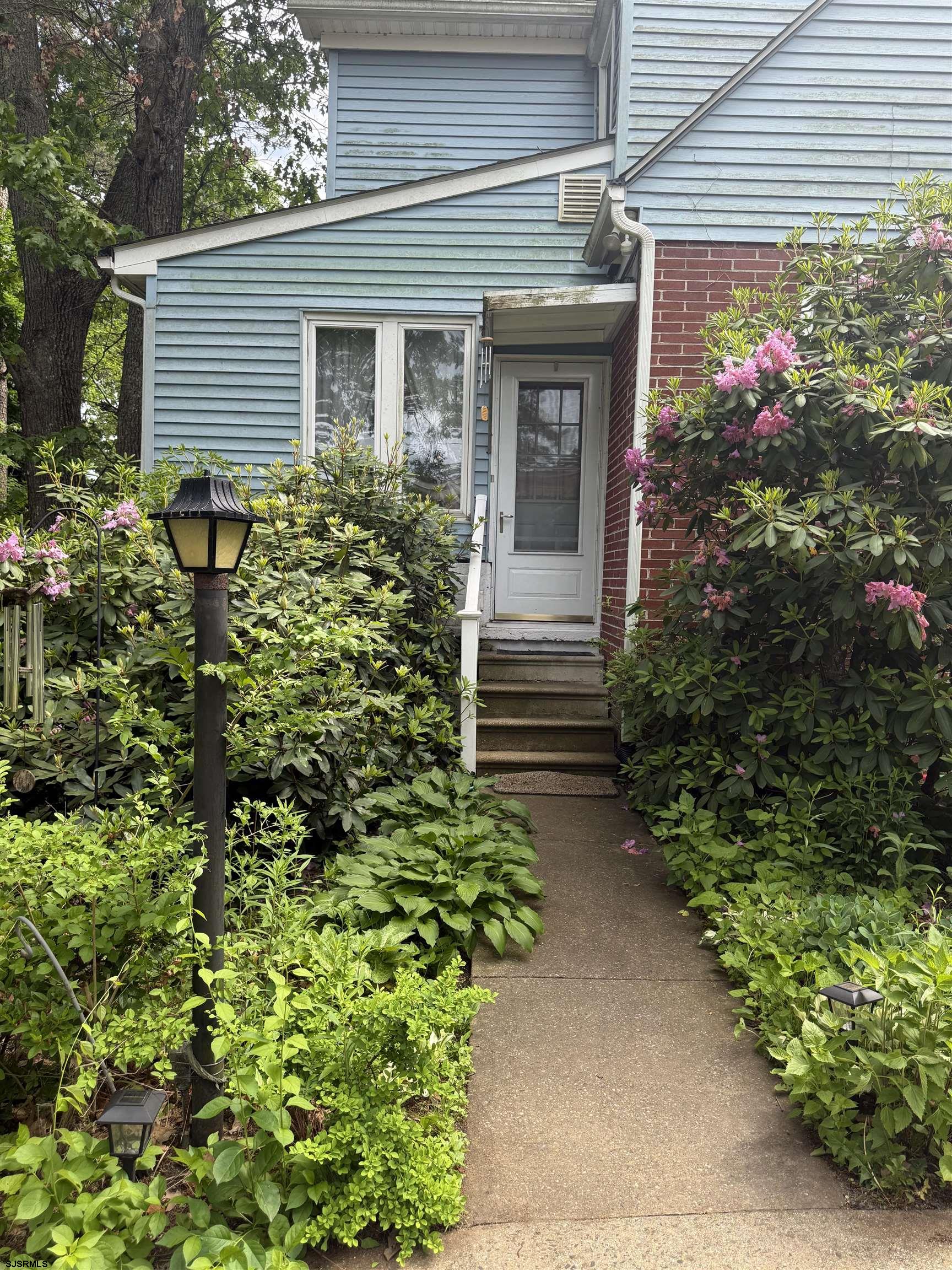 144 Pitney Road Absecon, NJ 08201 - Photo 3 of 47 a house with a flower garden
