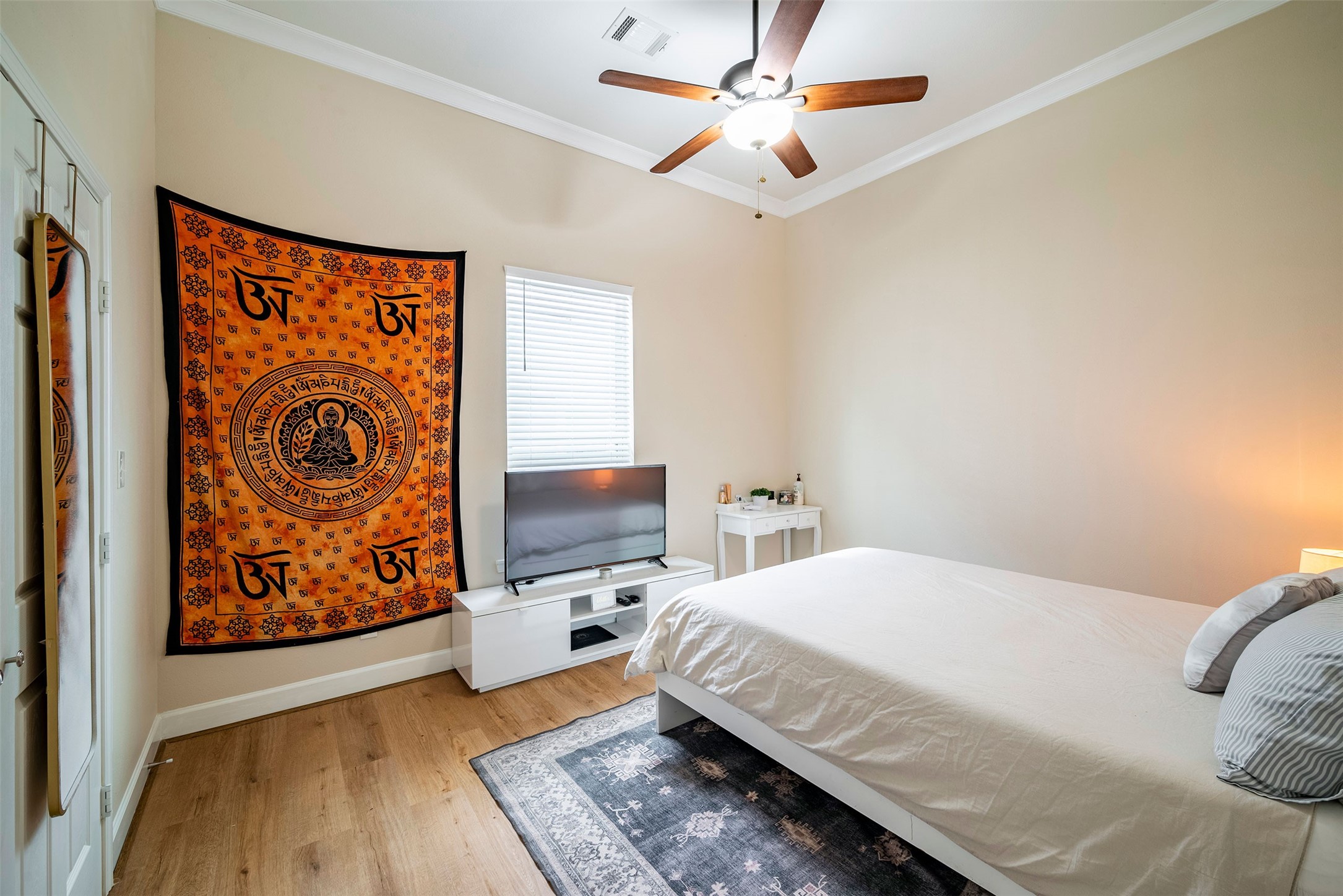 1924 Gano Street Houston, TX 77009 - Photo 10 of 18 a bedroom with a bed and a flat screen tv