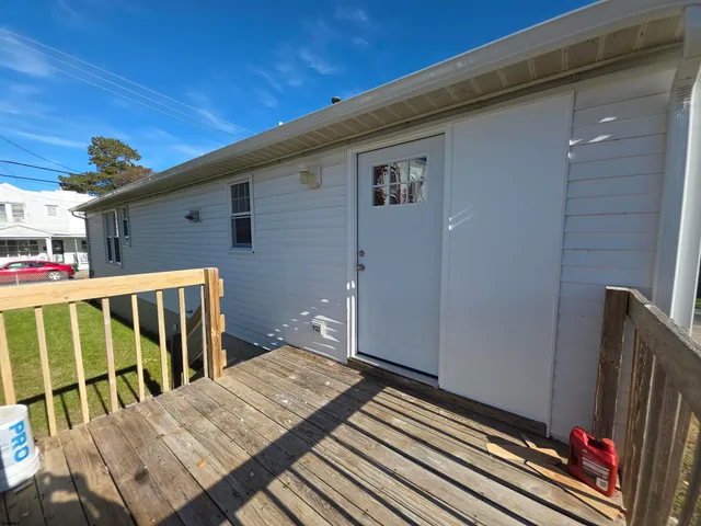a view of balcony with wooden floor and fence