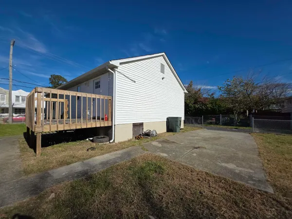 a view of backyard with deck and outdoor seating