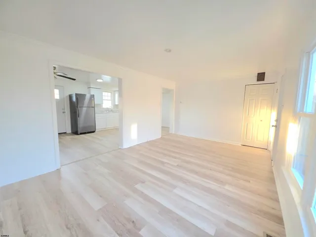 a view of a kitchen with a sink and a refrigerator