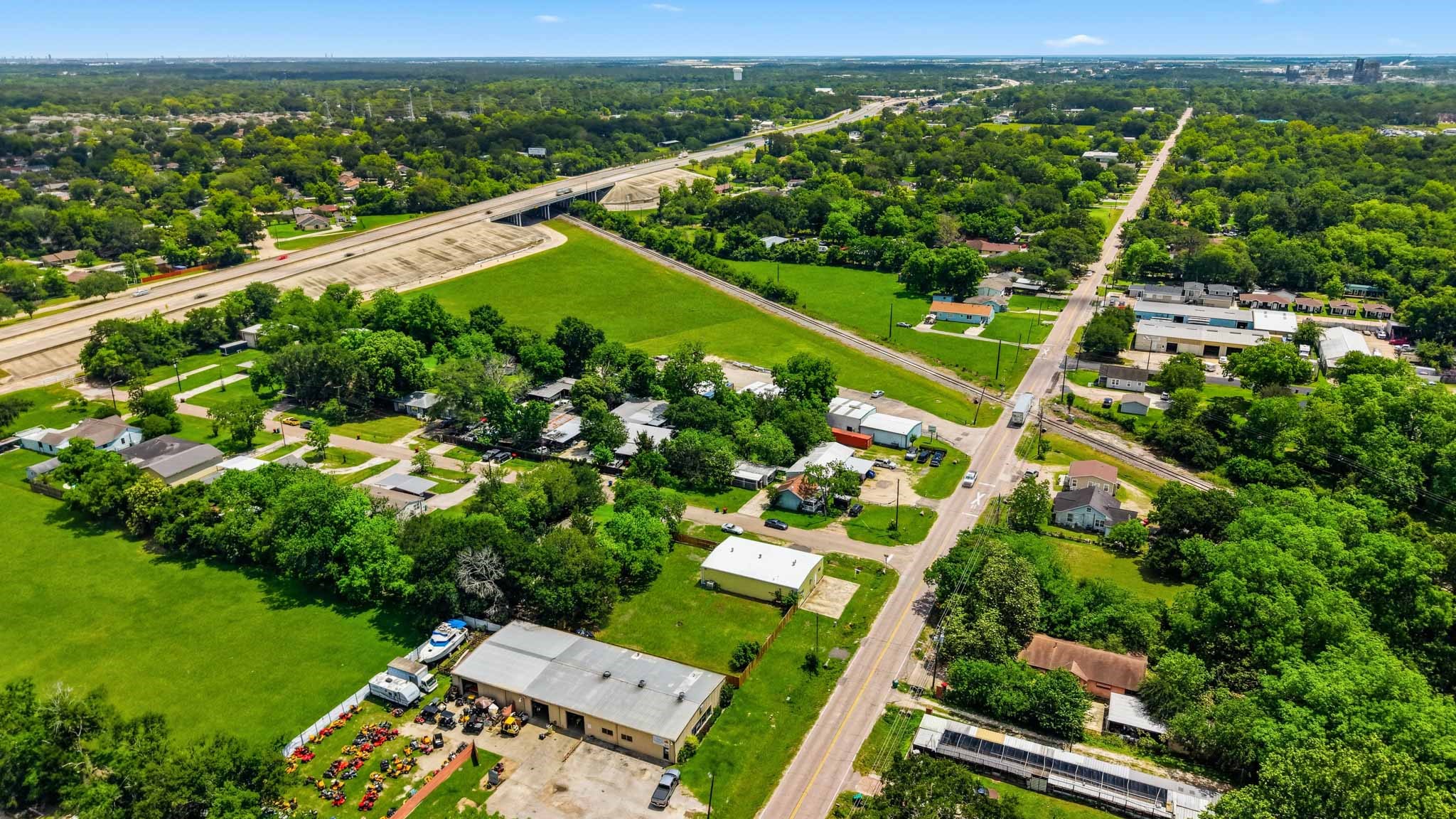 516 Cedar Bayou Road Baytown, TX 77520 - Photo 13 of 16 an aerial view of green landscape with trees houses and mountain view