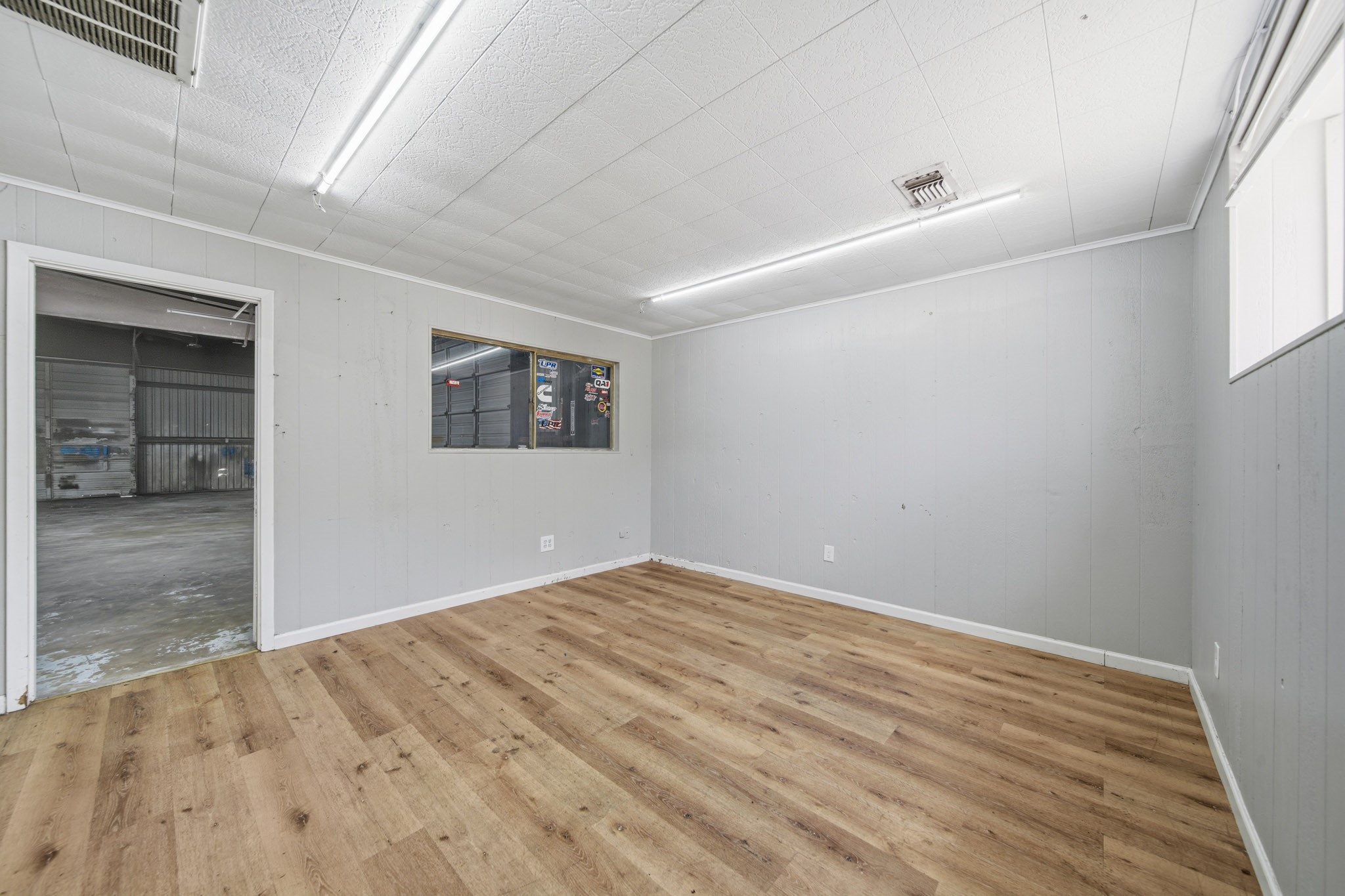 516 Cedar Bayou Road Baytown, TX 77520 - Photo 4 of 16 an empty room with wooden floor and windows