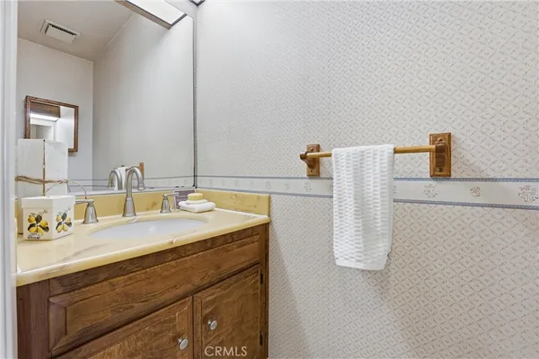 a bathroom with a sink vanity and a mirror