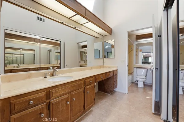 a spacious bathroom with a granite countertop sink mirror and toilet