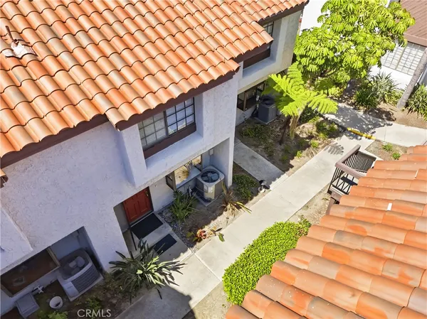 a view of a backyard with plants and a patio