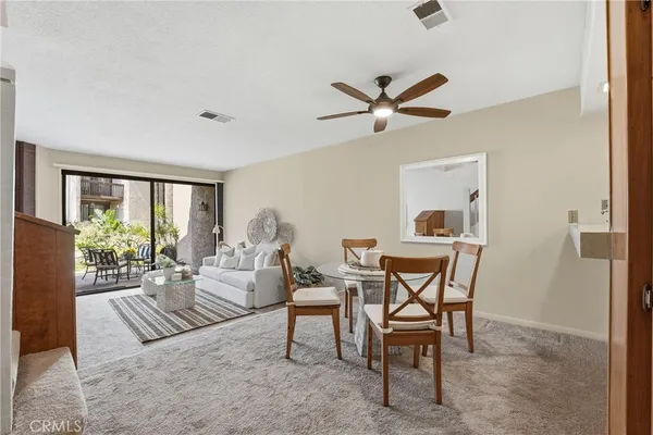 a dining room with furniture and a window