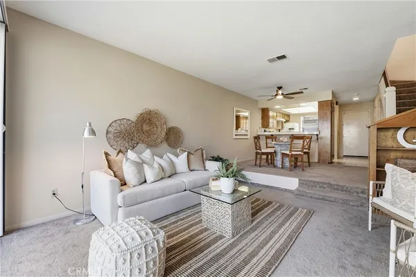a living room with furniture or couch and a dining table