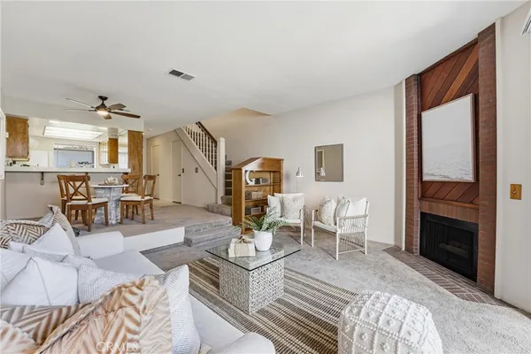 a living room with furniture and a fireplace