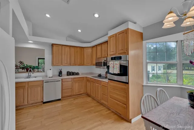 a kitchen with cabinets a sink and appliances