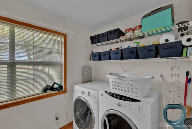 a view of washer and dryer with kitchen in the background