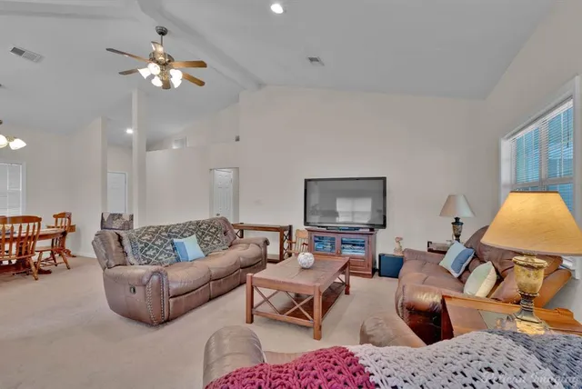 a living room with furniture and a chandelier