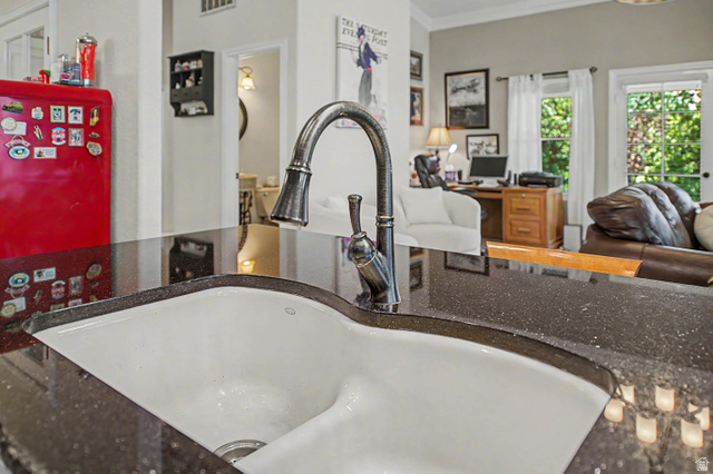 3034 Swiss Drive Santa Clara, UT 84765 - Photo 22 of 59 Kitchen sink featuring a dark speckled countertop, a white basin, and a gooseneck faucet