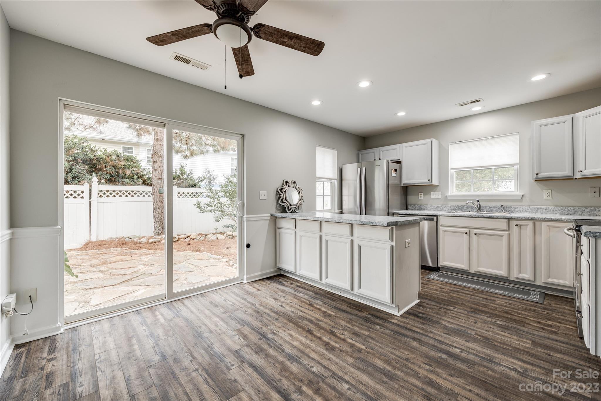 413 Caddy Street Fort Mill, SC 29715 - Photo 11 of 26 a kitchen with white cabinets and window