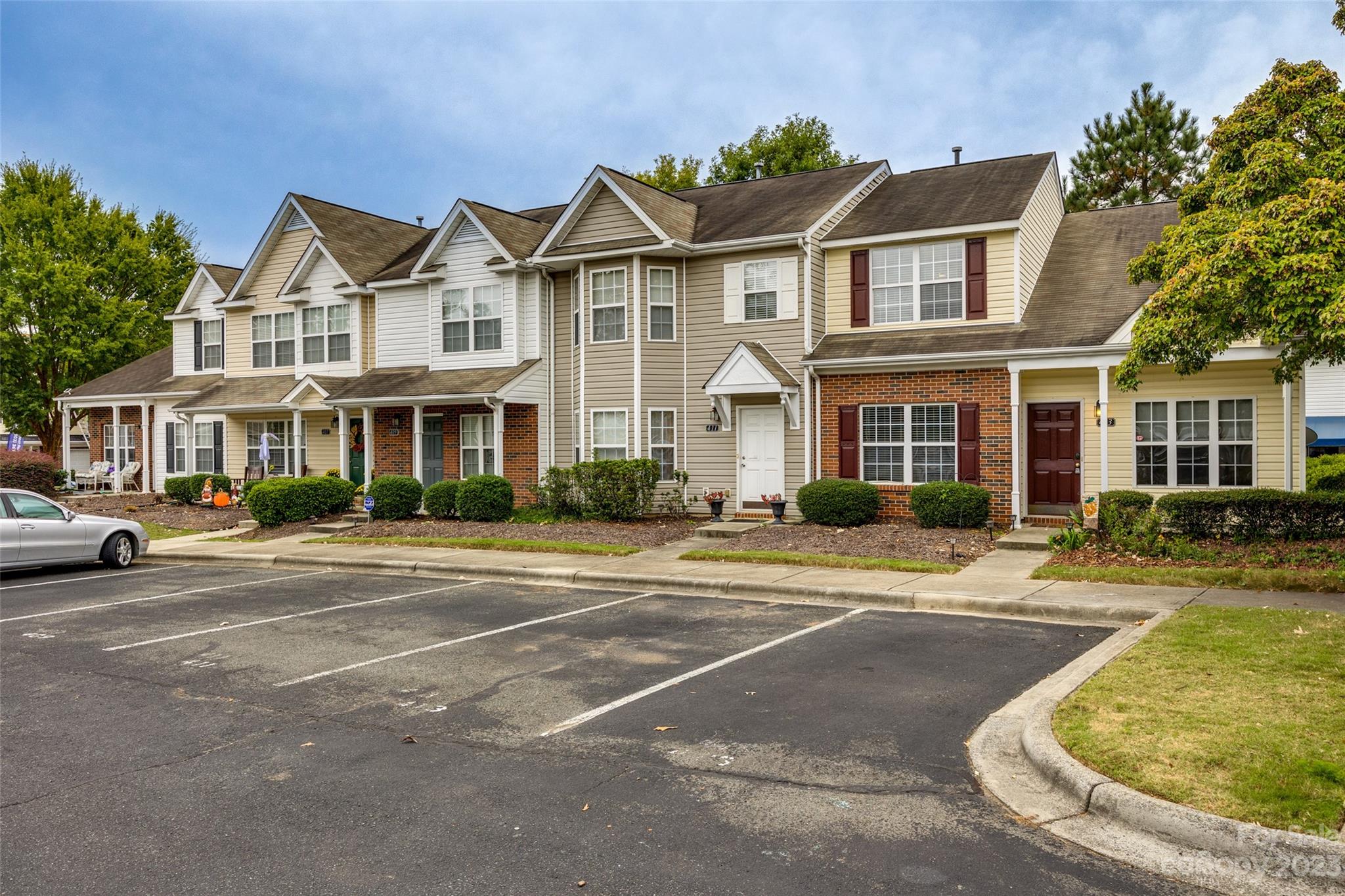 413 Caddy Street Fort Mill, SC 29715 - Photo 25 of 26 a view of a white house with a large windows and a yard with plants