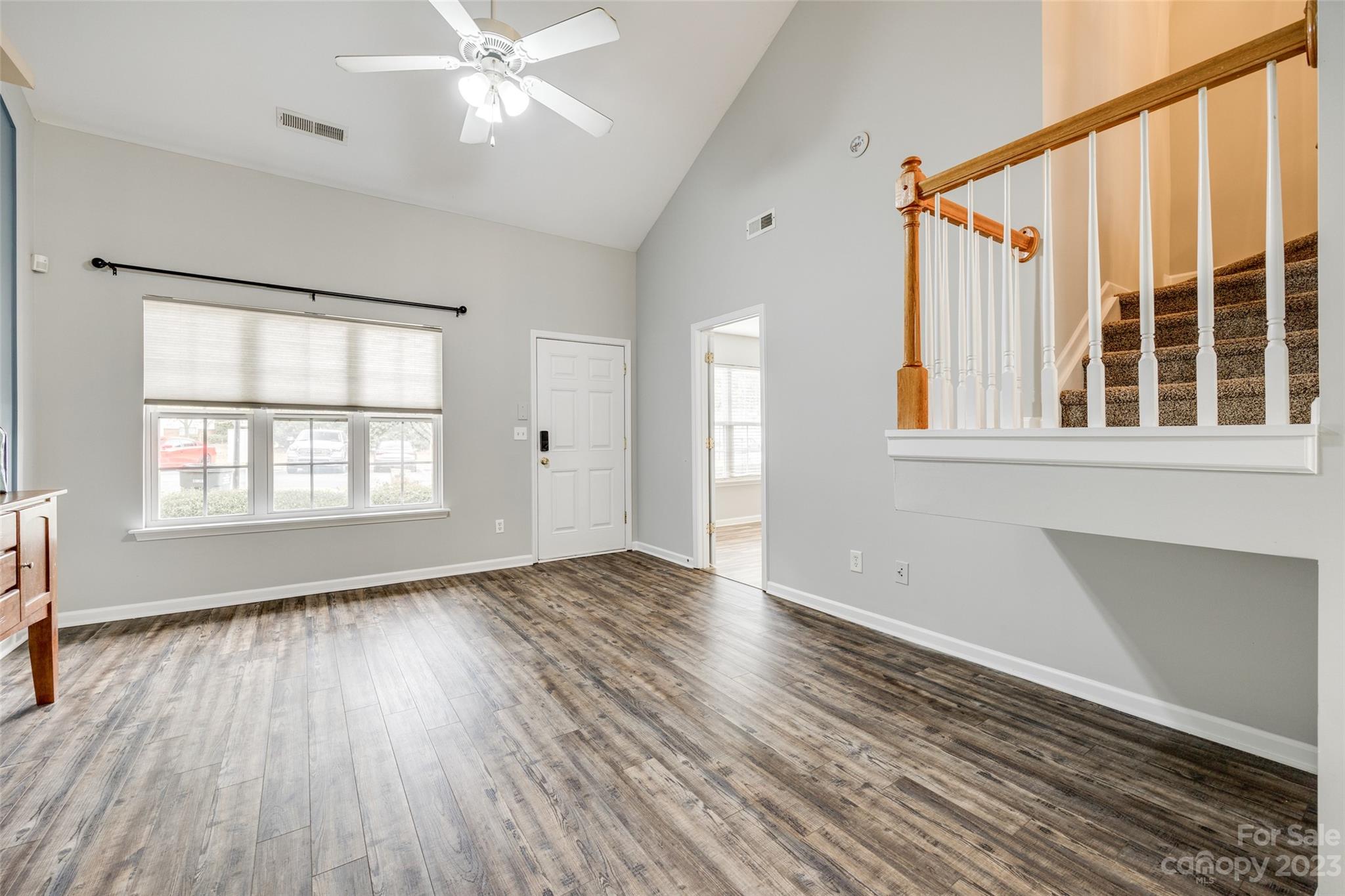 413 Caddy Street Fort Mill, SC 29715 - Photo 5 of 26 a view of an empty room with wooden floor and a window