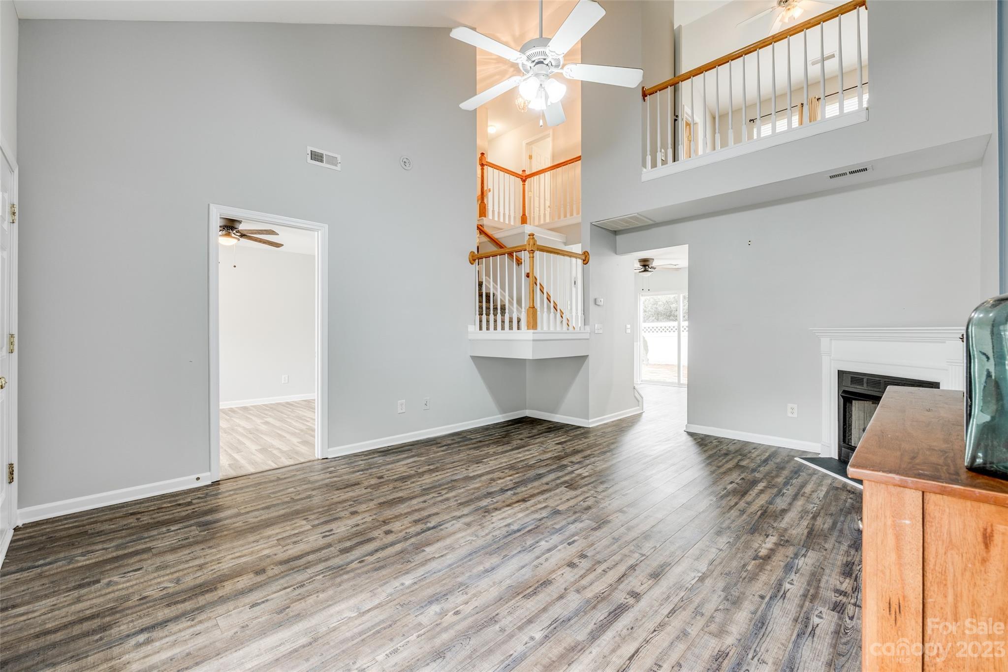 413 Caddy Street Fort Mill, SC 29715 - Photo 6 of 26 an empty room with wooden floor cabinet and windows