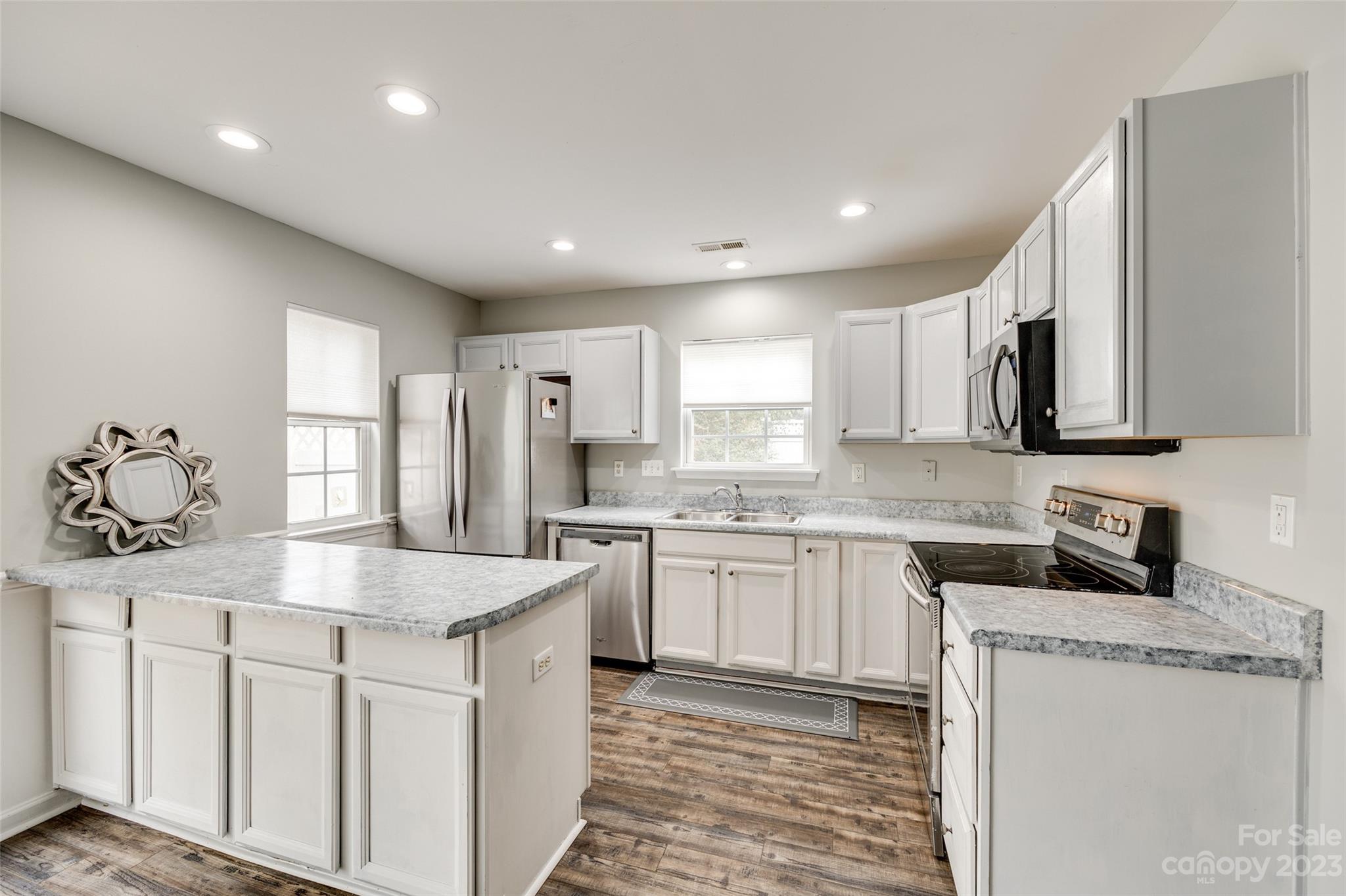 413 Caddy Street Fort Mill, SC 29715 - Photo 7 of 26 a kitchen with stainless steel appliances granite countertop refrigerator sink and cabinets
