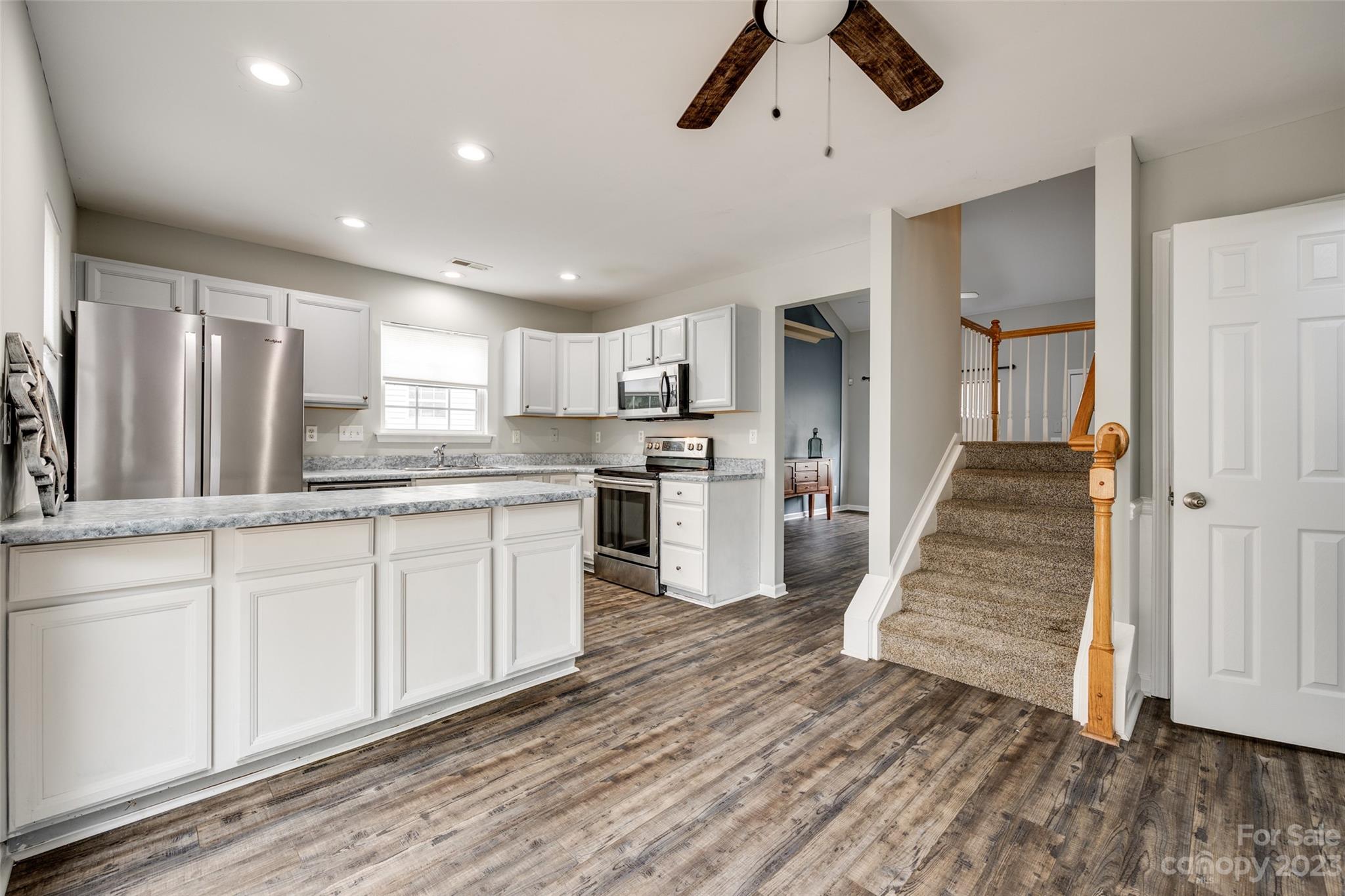 413 Caddy Street Fort Mill, SC 29715 - Photo 10 of 26 a kitchen with wooden floors and white appliances