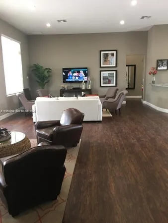 a living room with furniture and a lamp