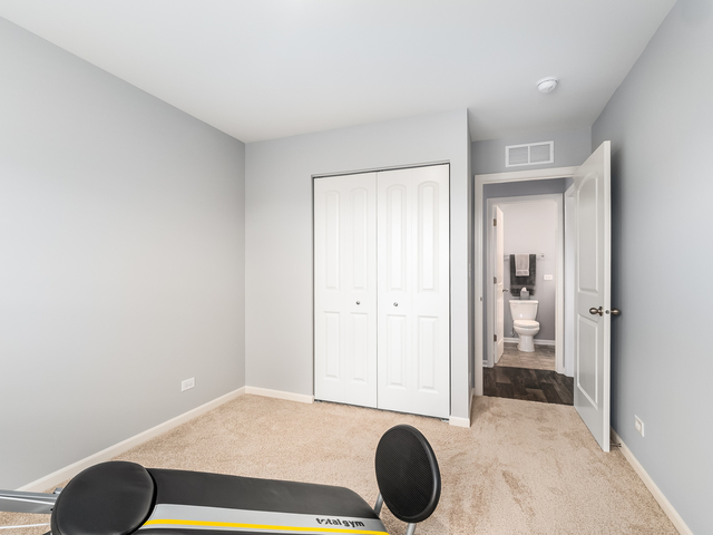 2421 Upland Road Pingree Grove, IL 60140 - Photo 15 of 21 a bedroom with a bed and a chair