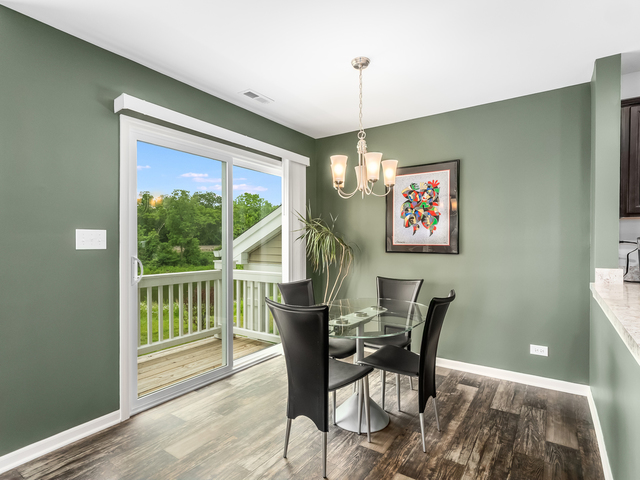 2421 Upland Road Pingree Grove, IL 60140 - Photo 4 of 21 a view of a dining room with furniture window and wooden floor