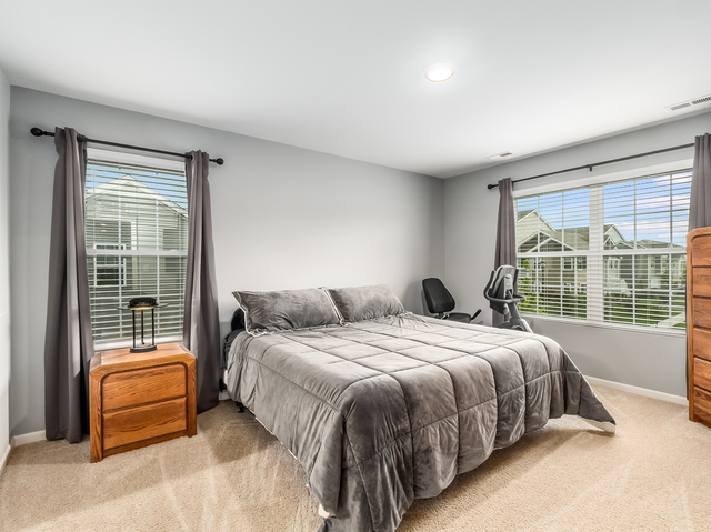 2421 Upland Road Pingree Grove, IL 60140 - Photo 5 of 21 a bedroom with a bed and glass door