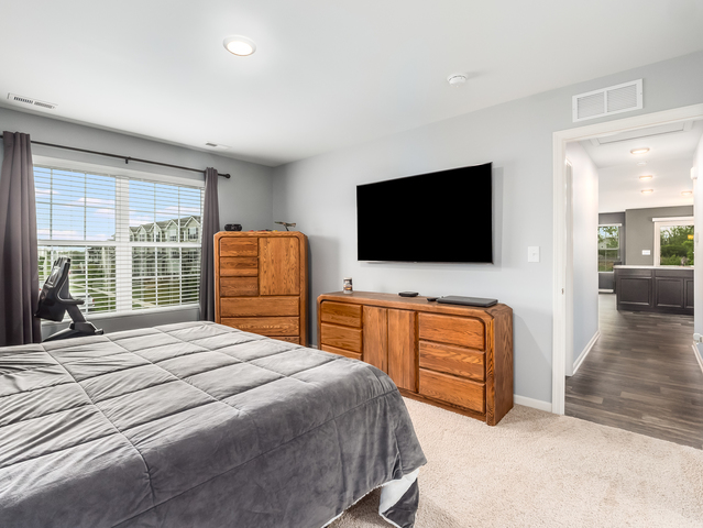 2421 Upland Road Pingree Grove, IL 60140 - Photo 10 of 21 a bedroom with a bed and a flat screen television