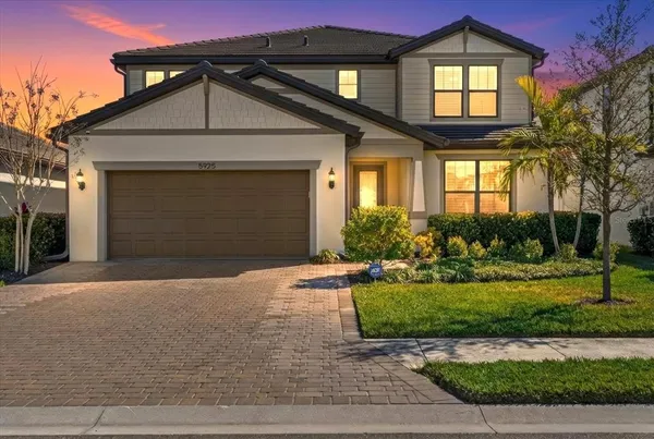 a front view of a house with a yard and garage