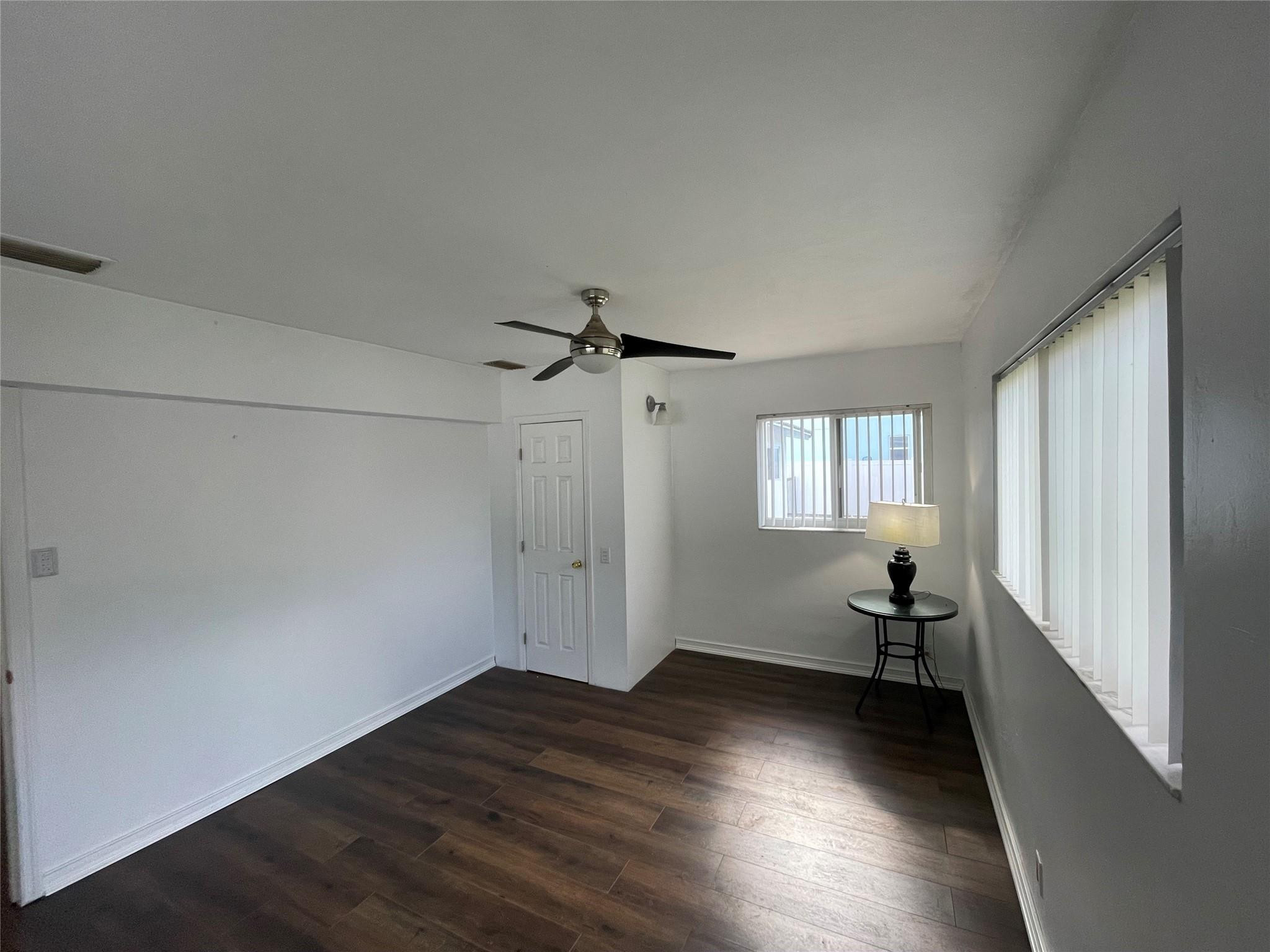 3231 Northeast 27th Terrace Lighthouse Point, FL 33064 - Photo 12 of 30 wooden floor in an empty room with a window