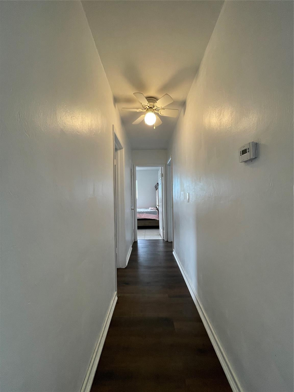 3231 Northeast 27th Terrace Lighthouse Point, FL 33064 - Photo 13 of 30 a view of a hallway with a chandelier fan