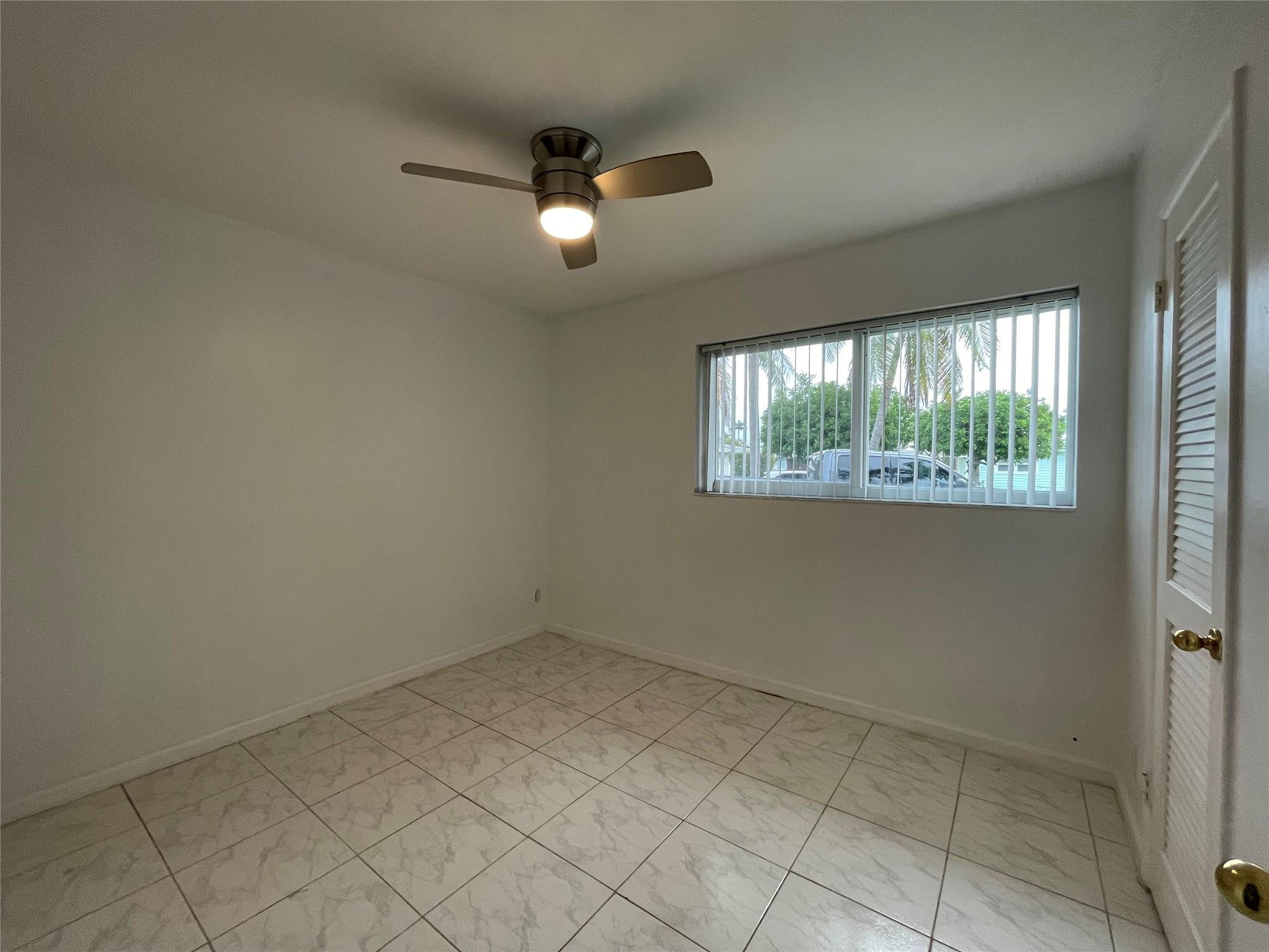 3231 Northeast 27th Terrace Lighthouse Point, FL 33064 - Photo 19 of 30 an empty room with windows
