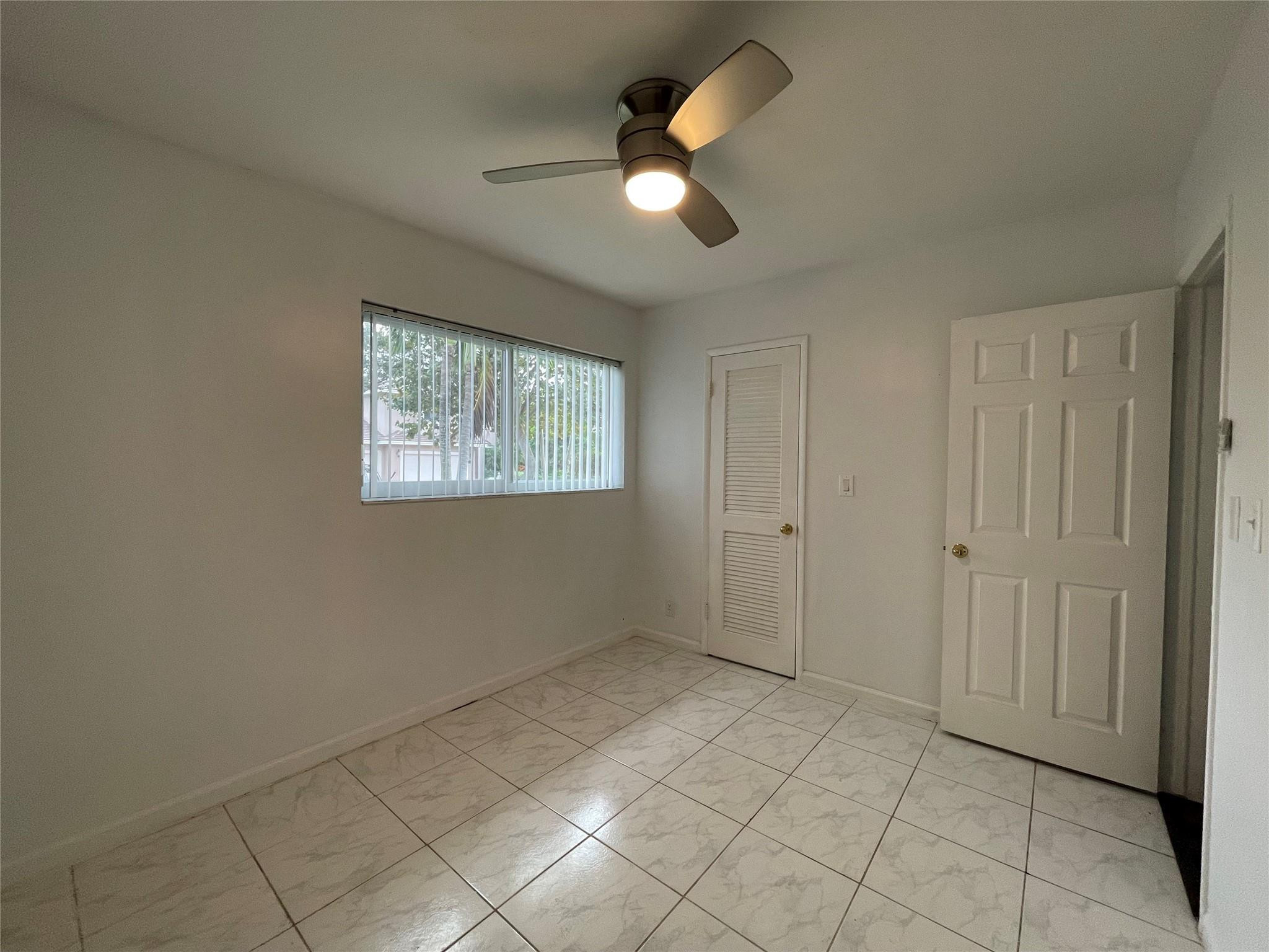 3231 Northeast 27th Terrace Lighthouse Point, FL 33064 - Photo 20 of 30 a view of an empty room with a window