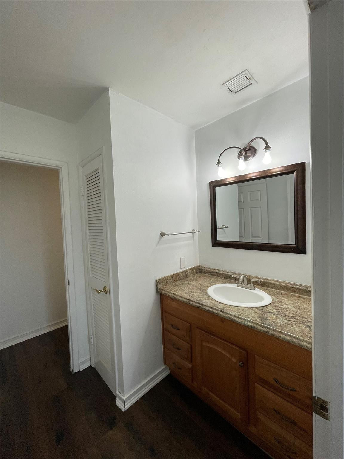 3231 Northeast 27th Terrace Lighthouse Point, FL 33064 - Photo 23 of 30 a bathroom with a granite countertop sink and mirror