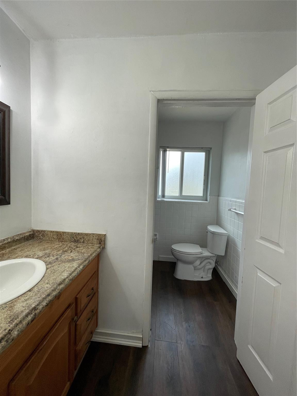 3231 Northeast 27th Terrace Lighthouse Point, FL 33064 - Photo 24 of 30 a bathroom with a granite countertop sink and a mirror