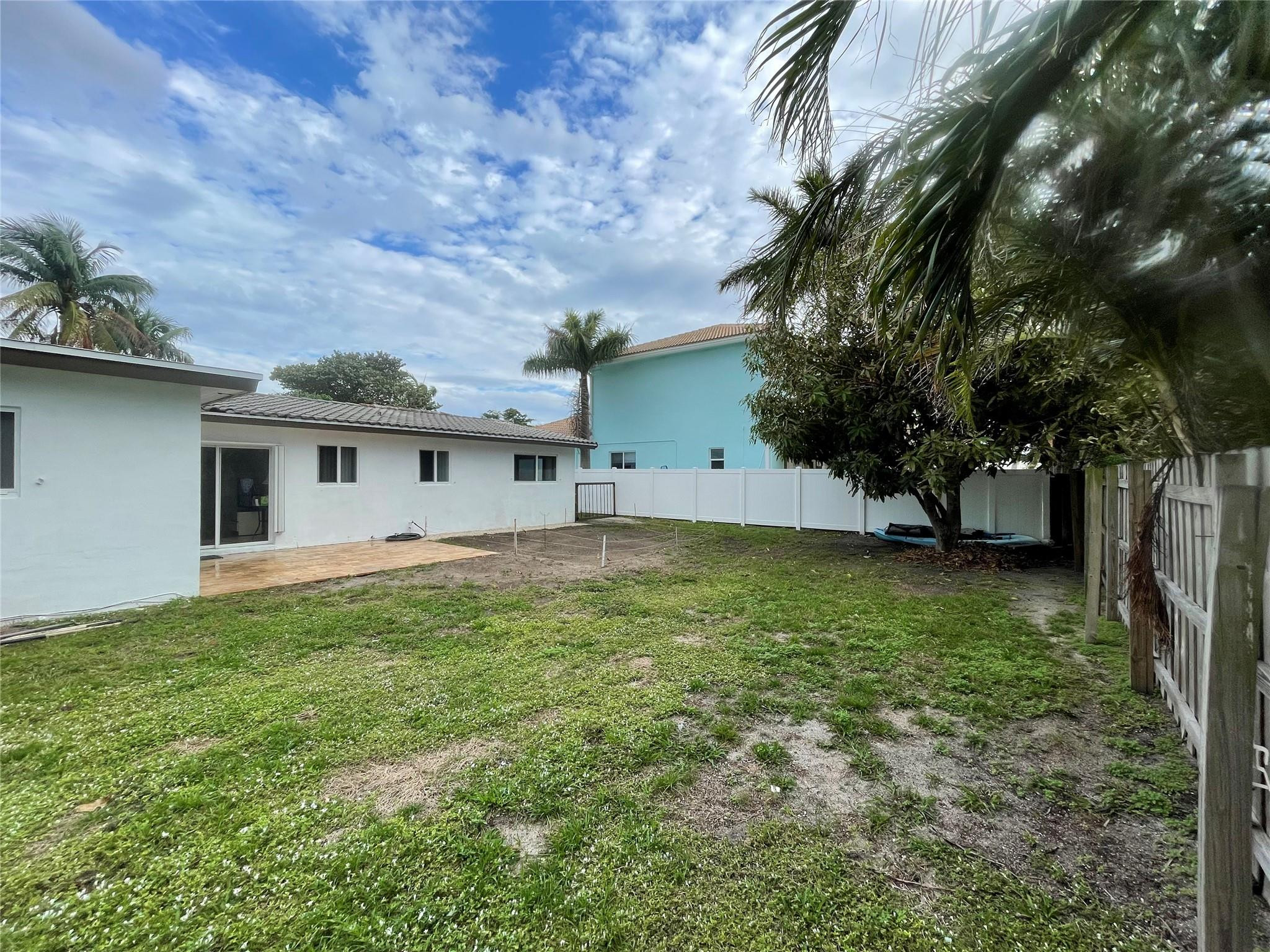 3231 Northeast 27th Terrace Lighthouse Point, FL 33064 - Photo 27 of 30 a view of a house with a backyard