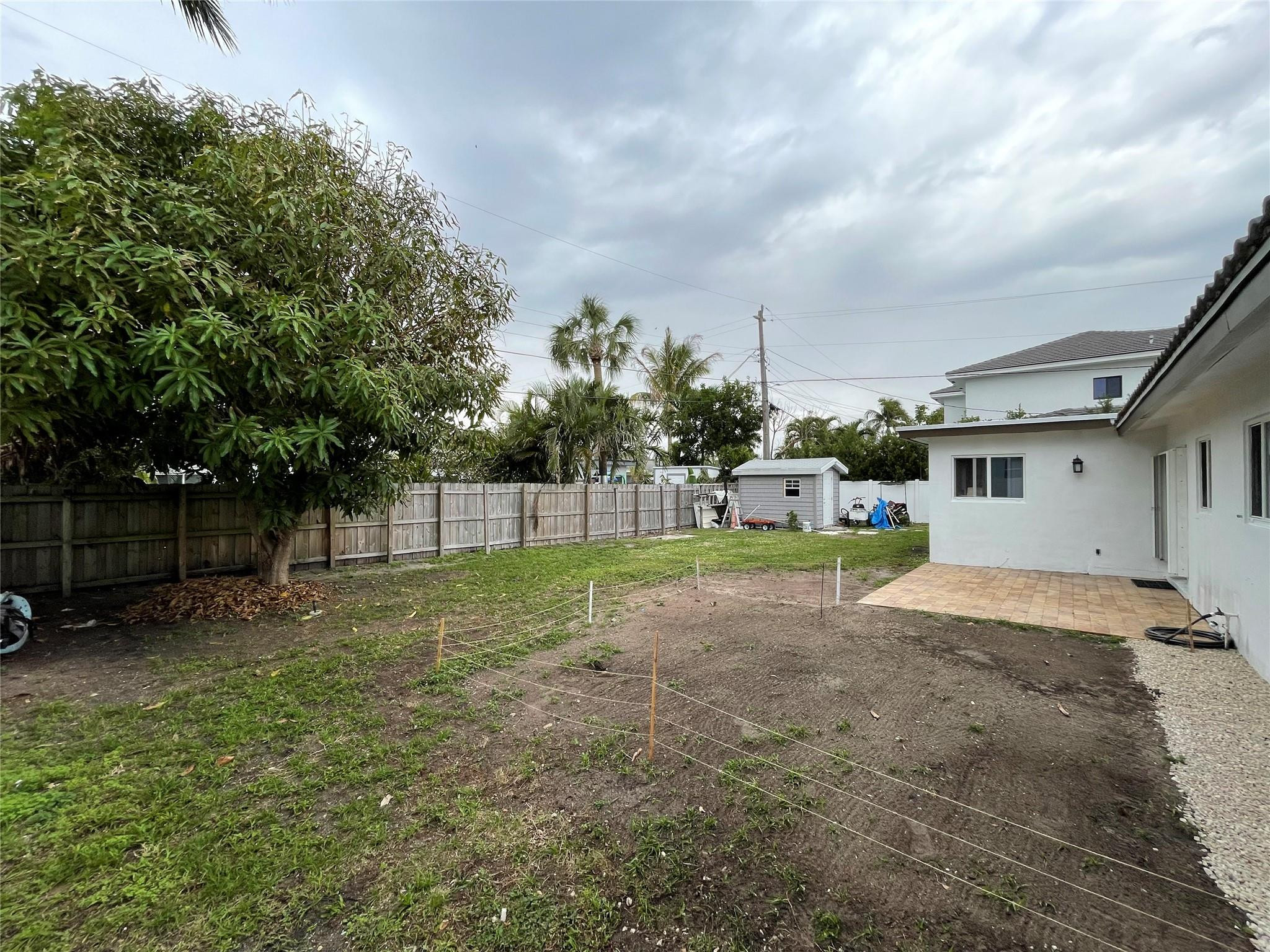 3231 Northeast 27th Terrace Lighthouse Point, FL 33064 - Photo 30 of 30 a view of backyard of house with green space