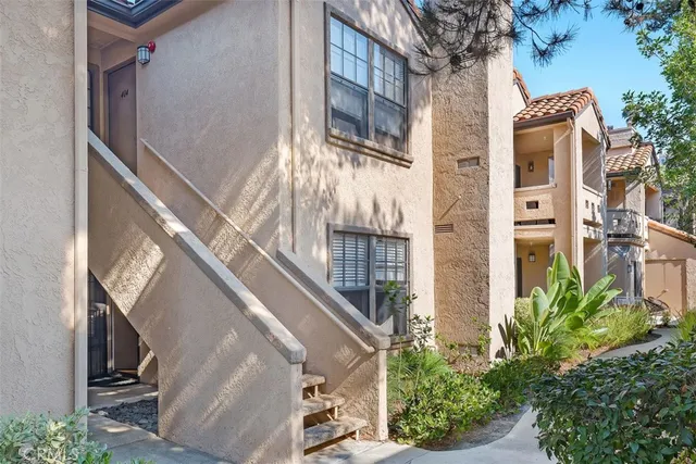 a front view of a house with plants