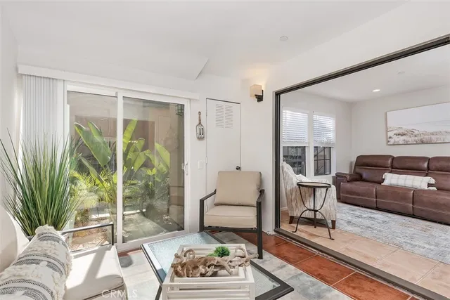 a kitchen with stainless steel appliances a table and chairs in it