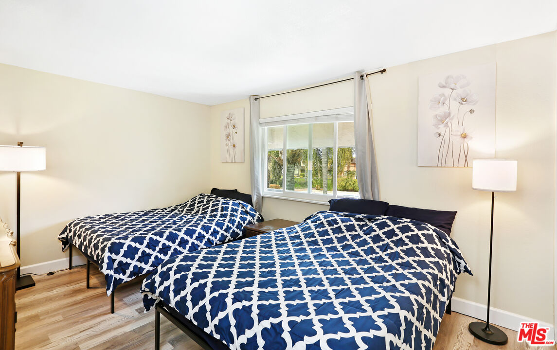 3519 Polk Street Riverside, CA 92505 - Photo 16 of 28 a bedroom with a bed and wooden floor