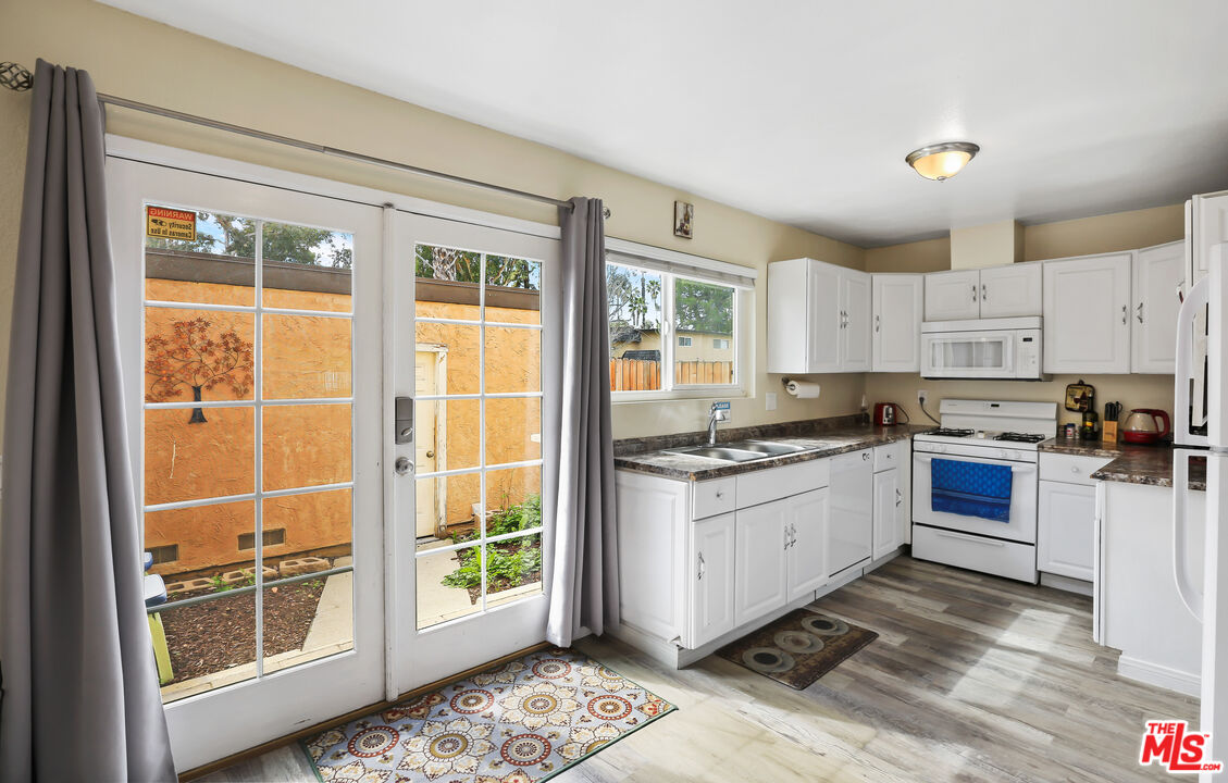 3519 Polk Street Riverside, CA 92505 - Photo 8 of 28 a kitchen with granite countertop a stove a sink and a refrigerator