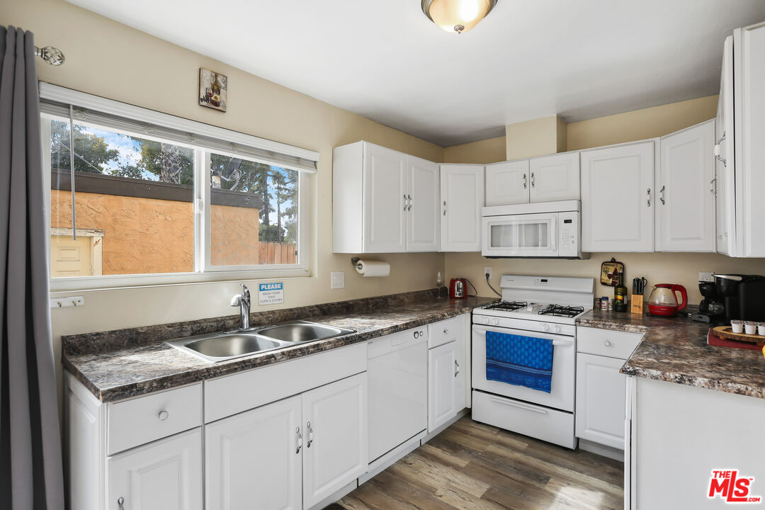 3519 Polk Street Riverside, CA 92505 - Photo 9 of 28 a kitchen with stainless steel appliances granite countertop a sink stove and cabinets