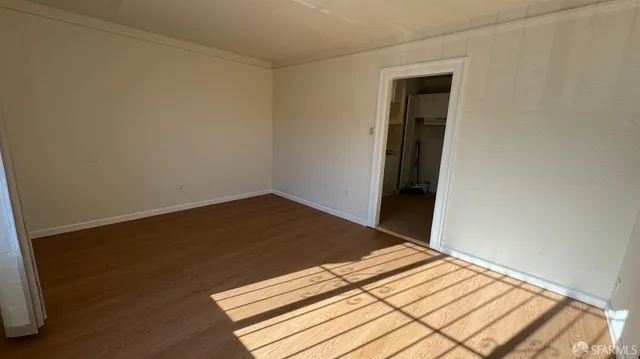 a view of a room with wooden floor