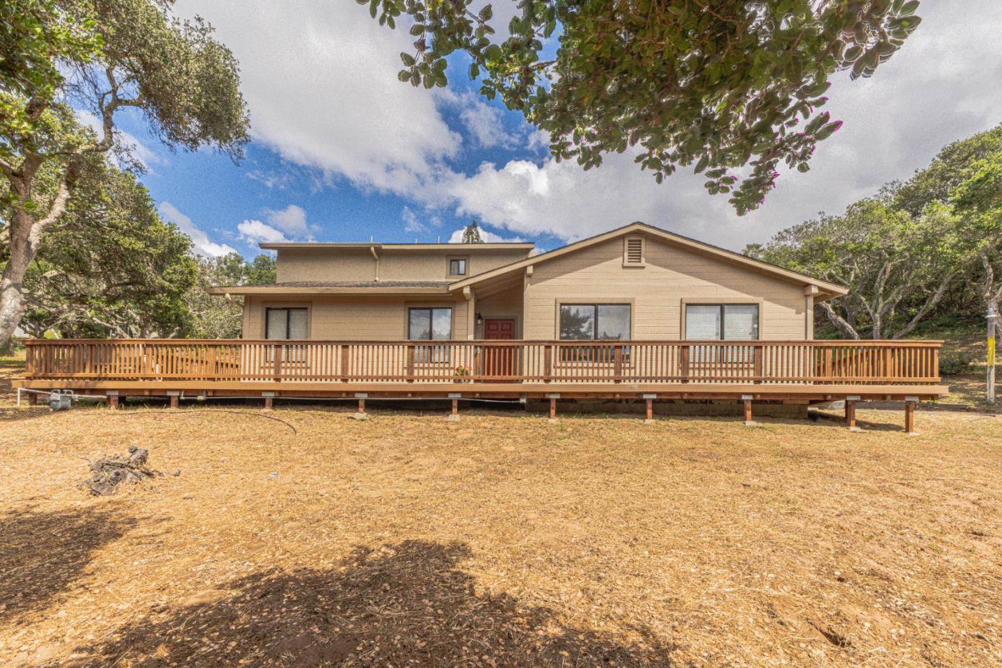 6959 Valle Pacifico Road Salinas, CA 93907 - Photo 2 of 45 a view of a white house with a big yard and large trees