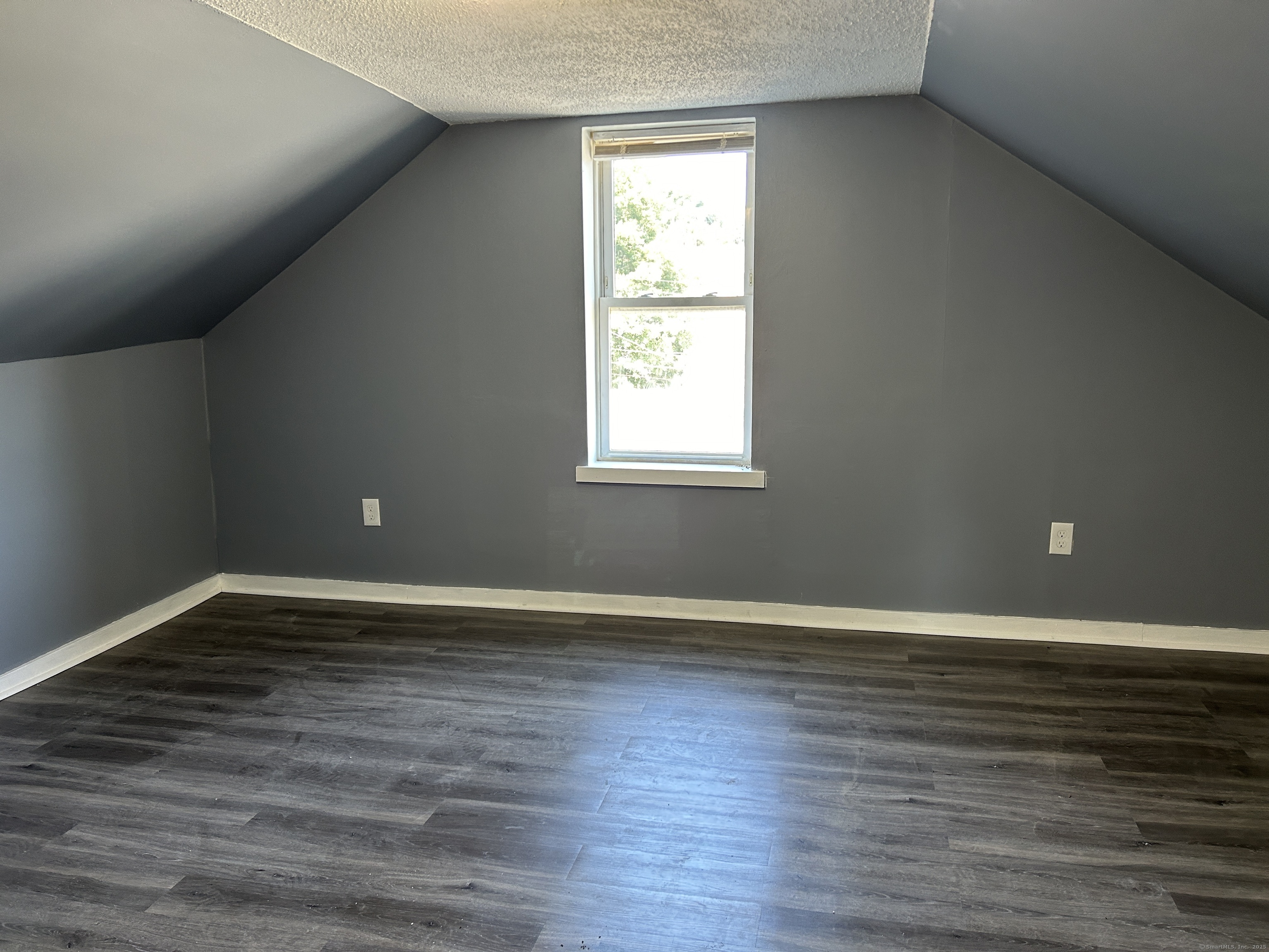164 Central Avenue Norwich, CT 06360 - Photo 11 of 16 a view of an empty room with wooden floor and a window
