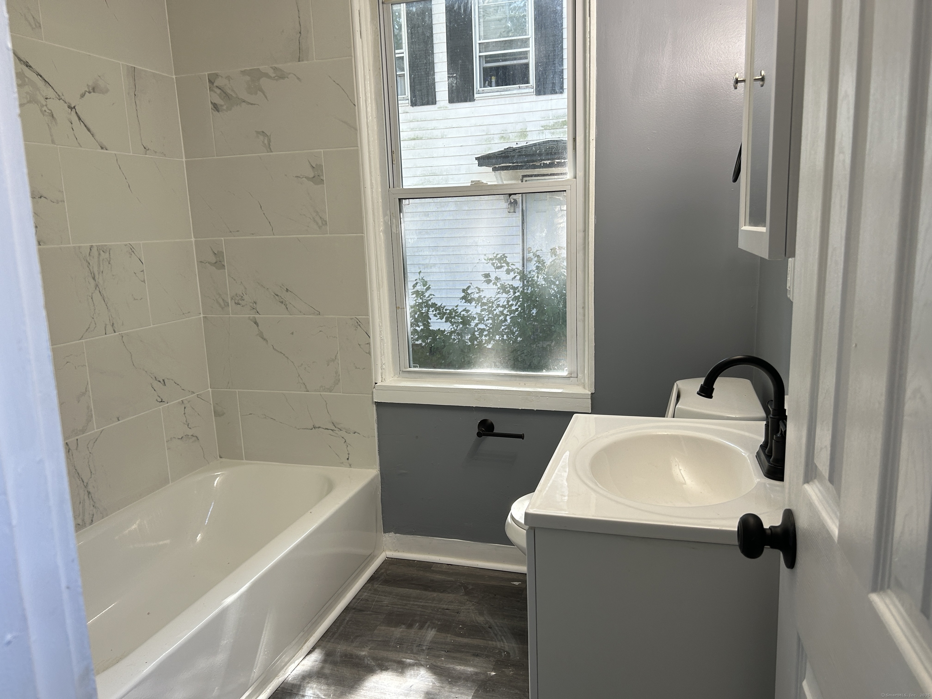 164 Central Avenue Norwich, CT 06360 - Photo 15 of 16 a bath tub sitting next to a window