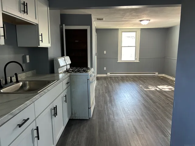 a kitchen with sink and cabinets